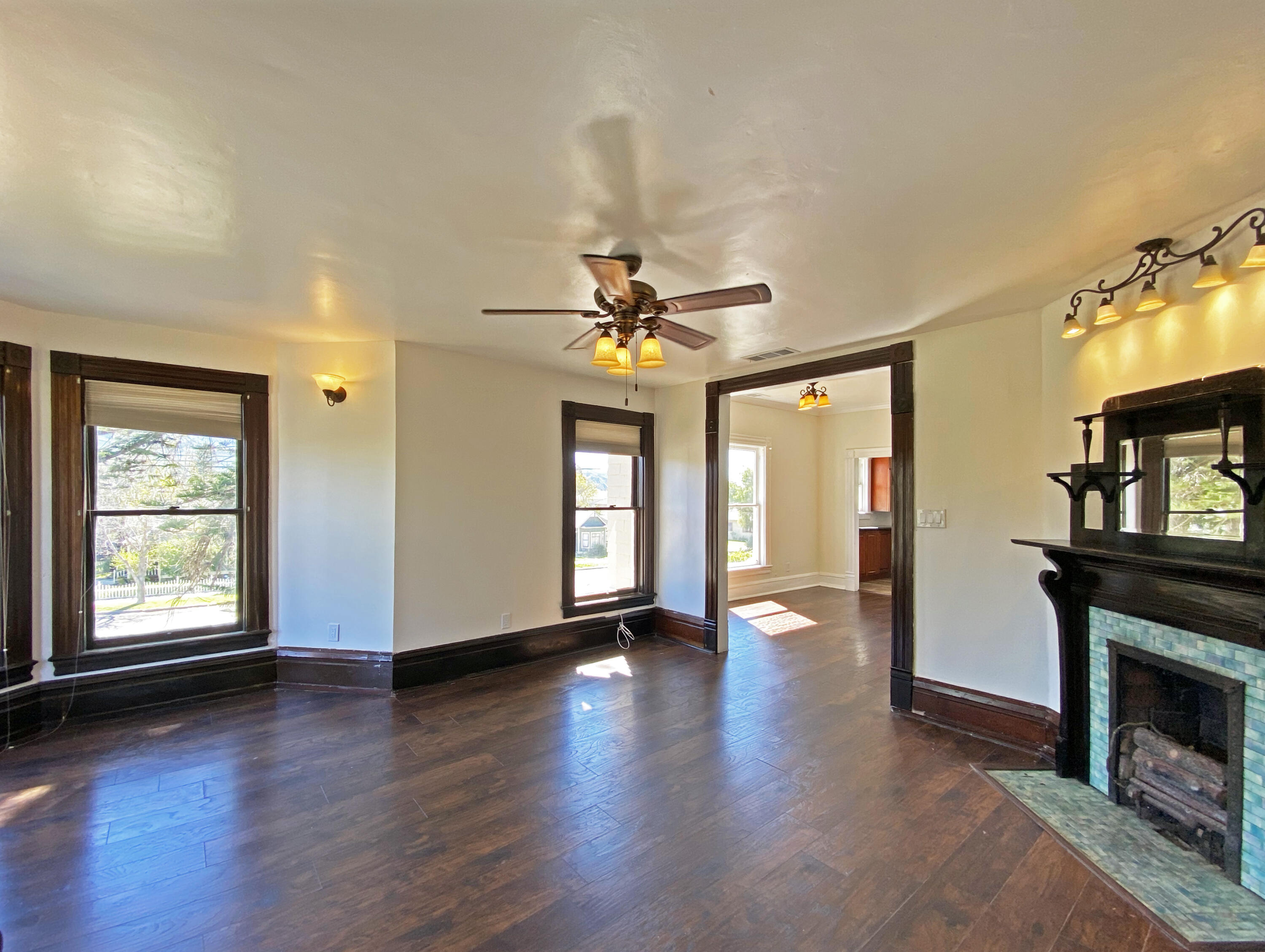 933 East Santa Paula Street, Unit C Santa Paula, CA 93060 - Photo 4 of 6 a view of a livingroom with wooden floor a fireplace and window