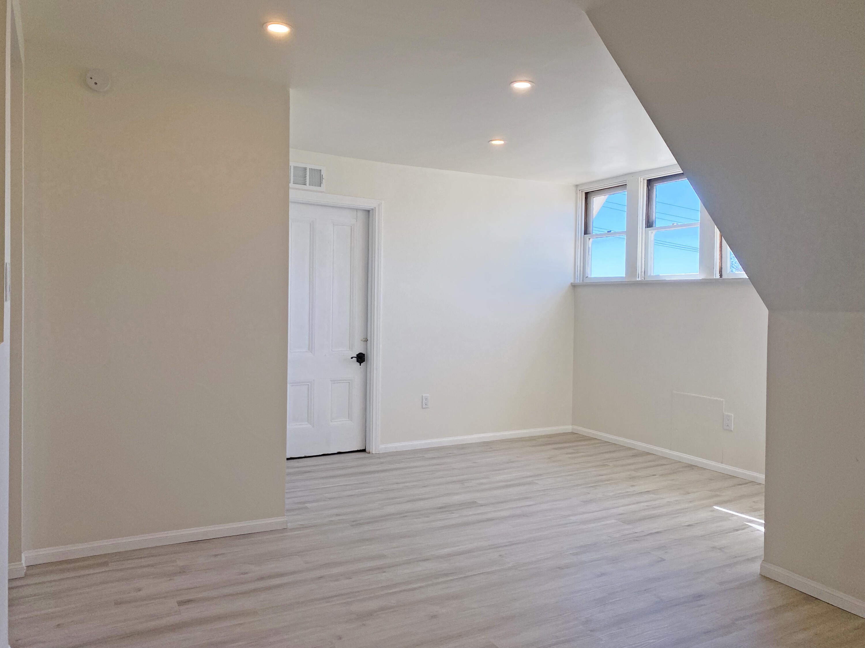 933 East Santa Paula Street, Unit C Santa Paula, CA 93060 - Photo 6 of 6 an empty room with wooden floor and windows
