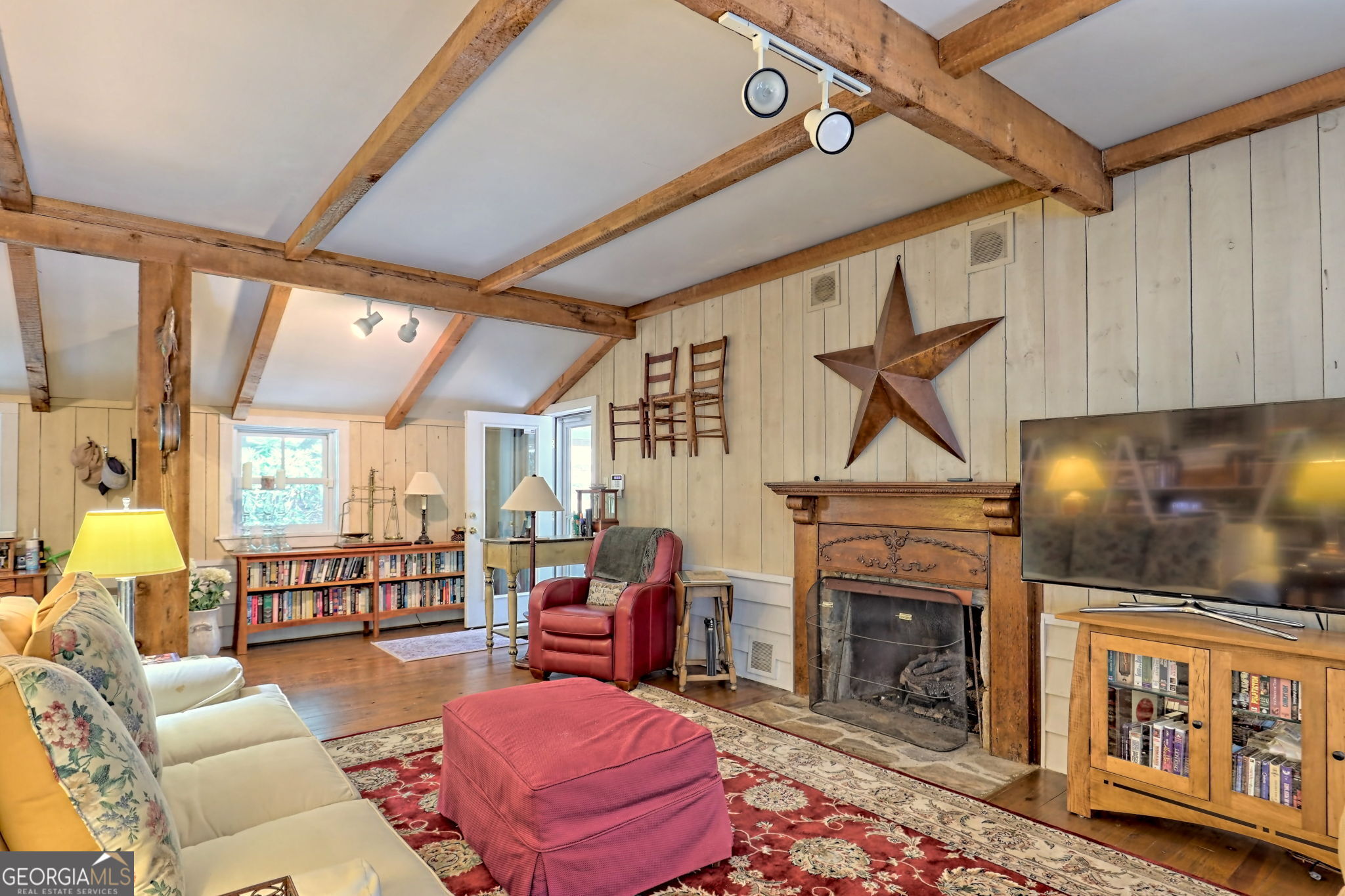 208 Colony Road Dillard, GA 30537 - Photo 29 of 80 a living room with furniture a rug and a fireplace