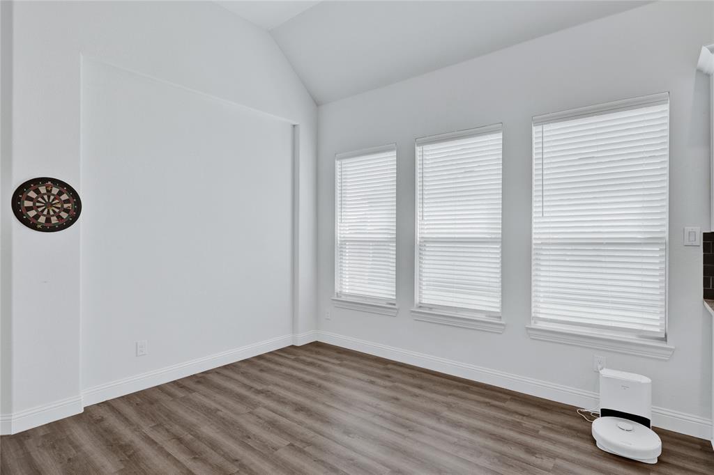 2307 Sam Street Mansfield, TX 76063 - Photo 15 of 23 Empty room featuring dark wood finished floors and vaulted ceiling