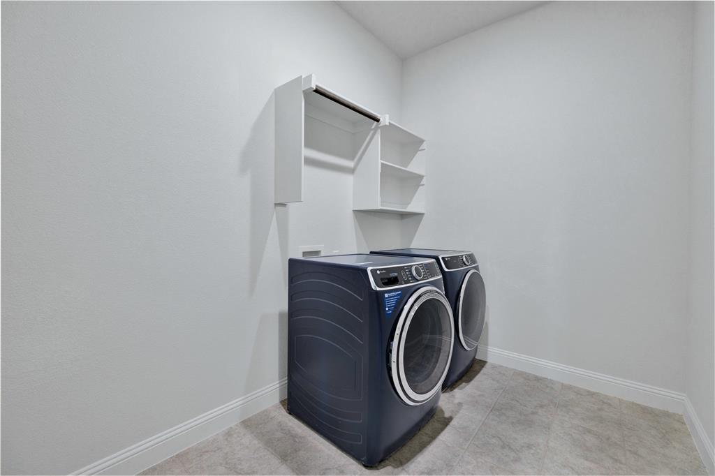 2307 Sam Street Mansfield, TX 76063 - Photo 19 of 23 Laundry area with baseboards and washing machine and dryer
