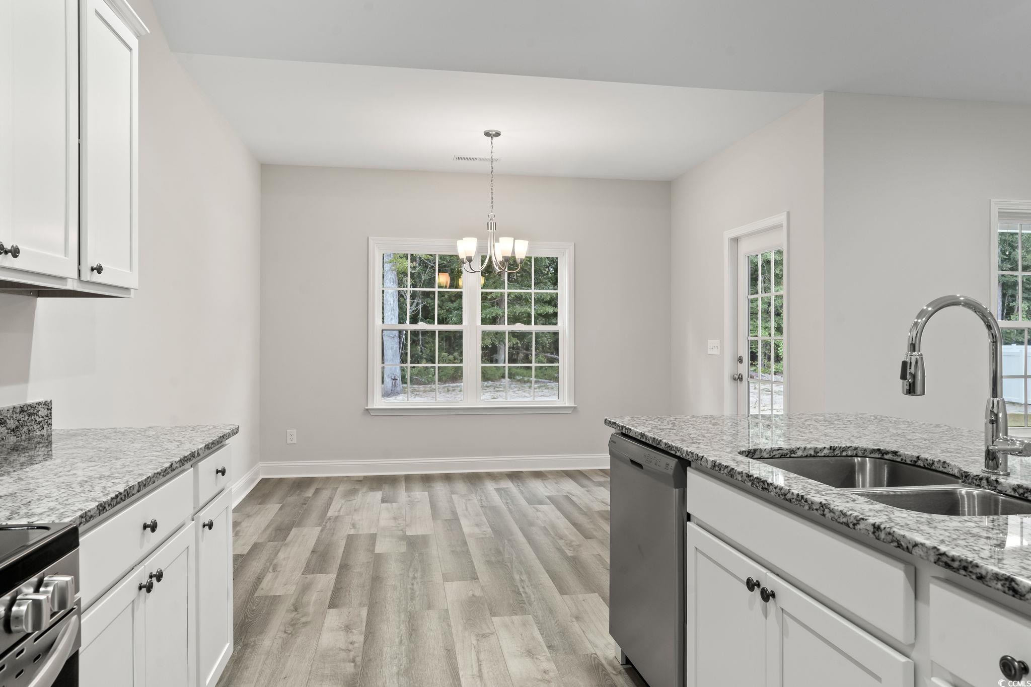 5987 Flossie Road Conway, SC 29527 - Photo 17 of 38 Kitchen with white cabinetry, light wood-type floo