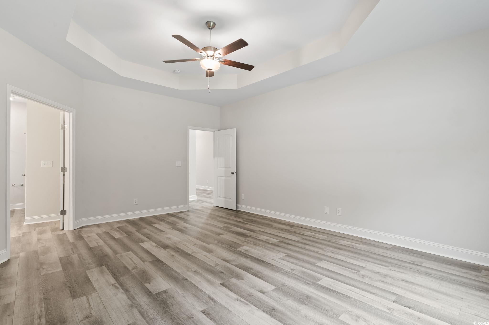 5987 Flossie Road Conway, SC 29527 - Photo 24 of 38 Unfurnished bedroom featuring a raised ceiling, li