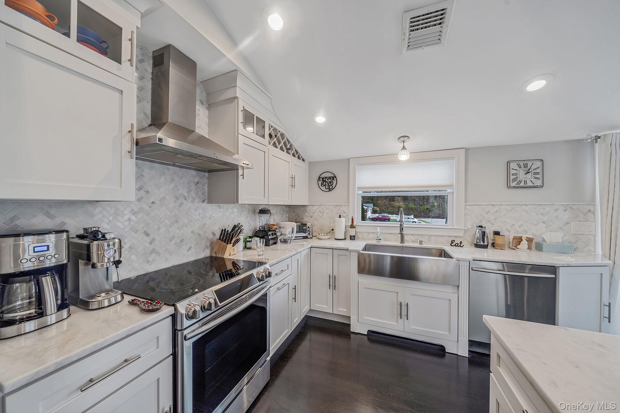110 Stephen Road Bayport, NY 11705 - Photo 18 of 39 a kitchen with white cabinets and white appliances