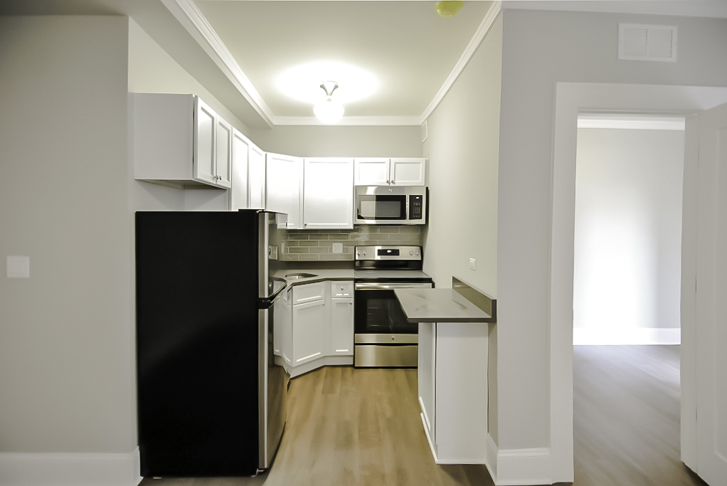 817 West Lakeside Place, Unit 305 Chicago, IL 60640 - Photo 4 of 23 a kitchen with kitchen island a counter top space a sink and appliances