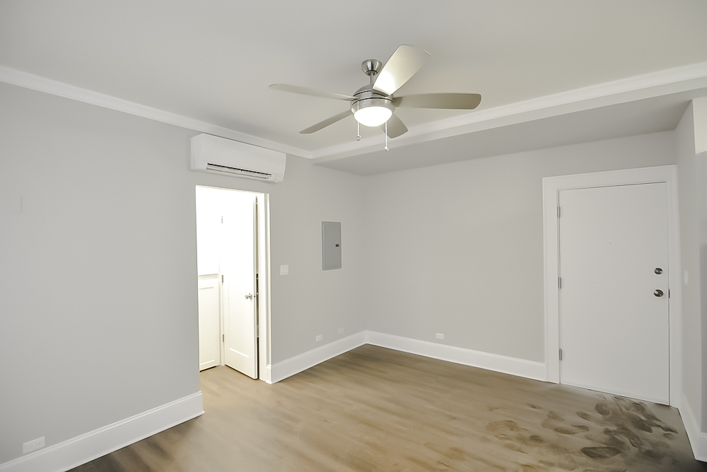817 West Lakeside Place, Unit 305 Chicago, IL 60640 - Photo 9 of 23 an empty room with wooden floor fan and windows