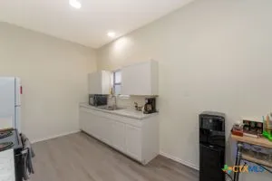 a room with a sink and a stove top oven