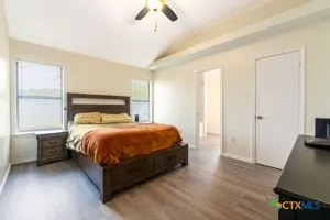 a bedroom with a bed and wooden floor