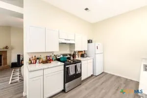 a kitchen with a sink stove and cabinets