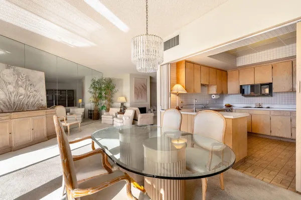 a dining room with furniture a window and kitchen view