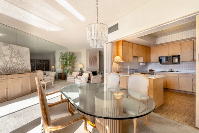 a dining room with furniture a window and kitchen view