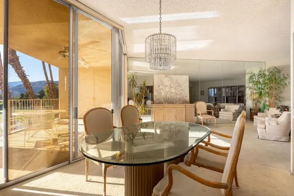 a view of a dining room with furniture wooden floor and chandelier
