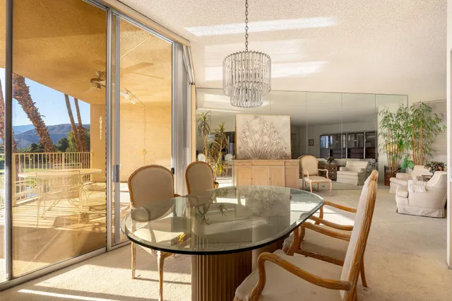 a view of a dining room with furniture wooden floor and chandelier