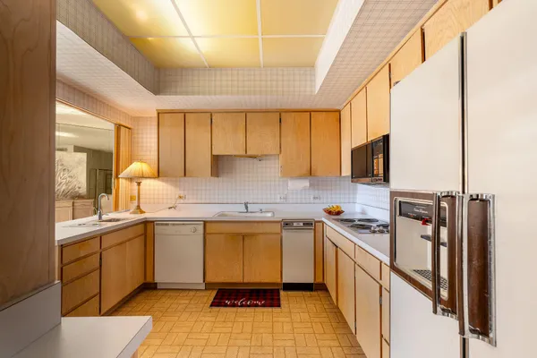 a kitchen with a sink appliances cabinets and a counter top space