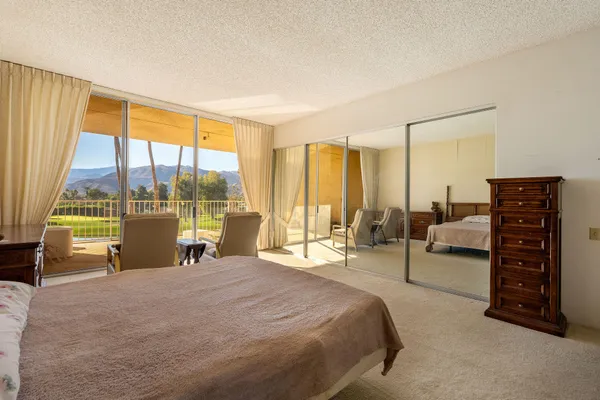 a spacious bedroom with a large bed and a large window