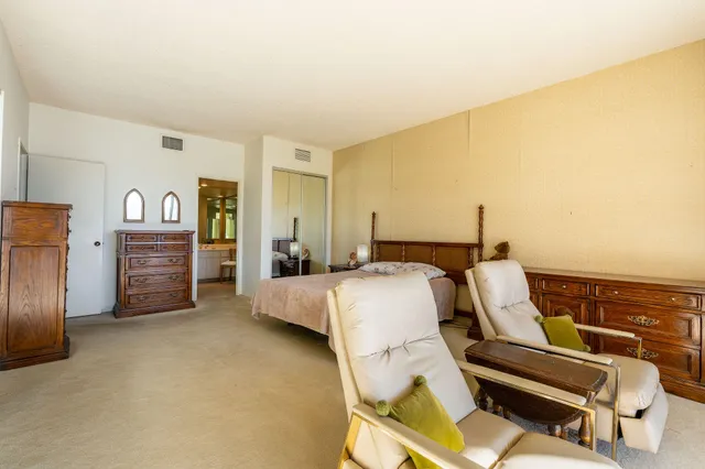 a bed room with a bed and dresser