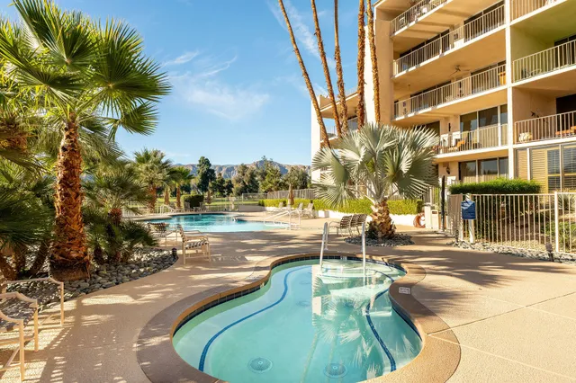 a view of a swimming pool with a lounge chairs