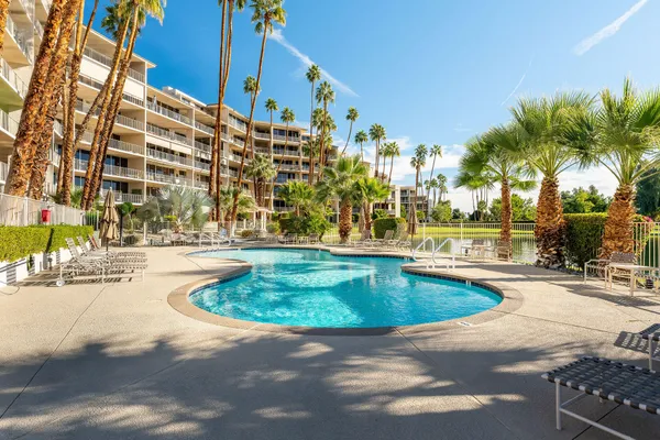 a swimming pool with outdoor seating and yard