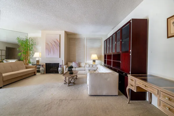 a living room with furniture gym equipment and a fireplace