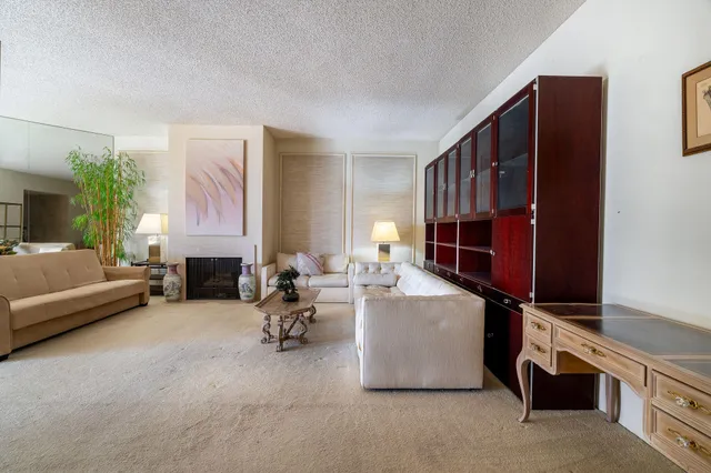 a living room with furniture gym equipment and a fireplace