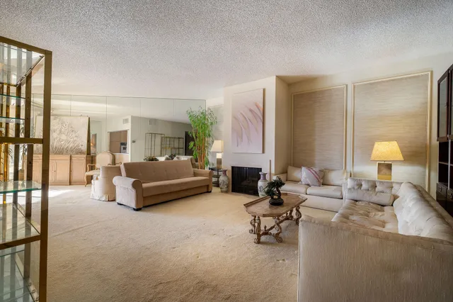 a living room with furniture and a lamp