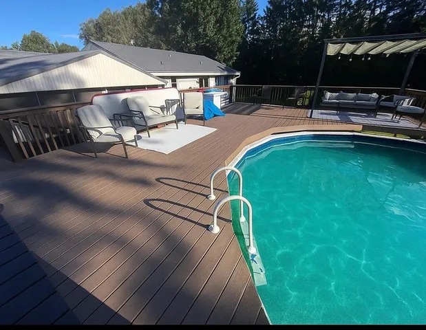swimming pool view with a seating space