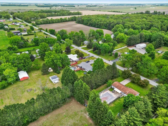 an aerial view of a houses with a yard
