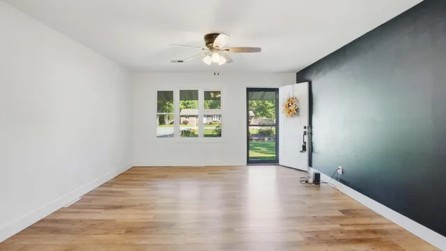 wooden floor in an empty room with a window