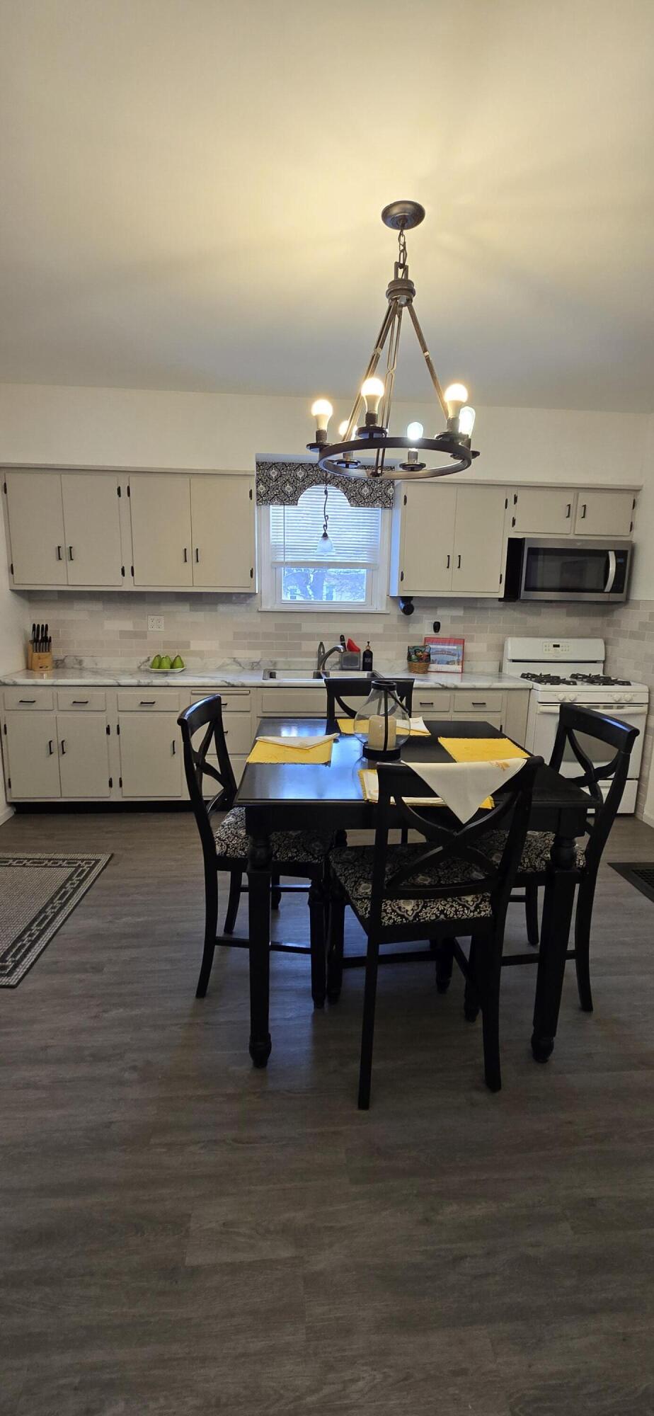 1647 Myrtle Avenue, Unit 1 Whiting, IN 46394 - Photo 4 of 20 a view of a dining room with furniture and wooden floor