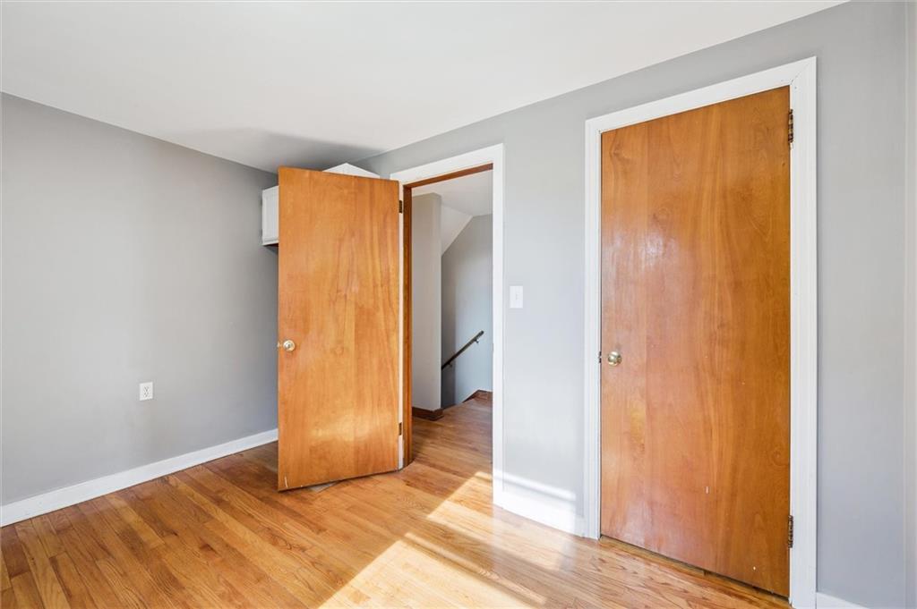 1167 Lapish Road Pittsburgh, PA 15212 - Photo 16 of 45 a view of an empty room with wooden floor and a window