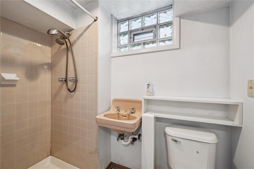 1167 Lapish Road Pittsburgh, PA 15212 - Photo 33 of 45 a bathroom with a sink a toilet and shower
