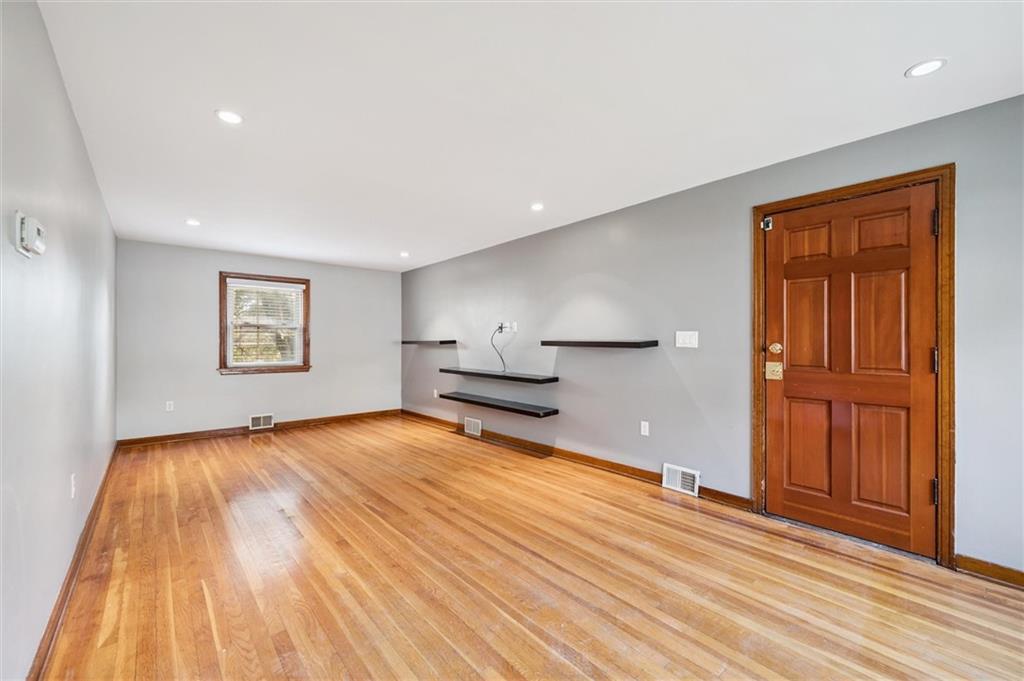 1167 Lapish Road Pittsburgh, PA 15212 - Photo 5 of 45 a view of an empty room with wooden floor and a window