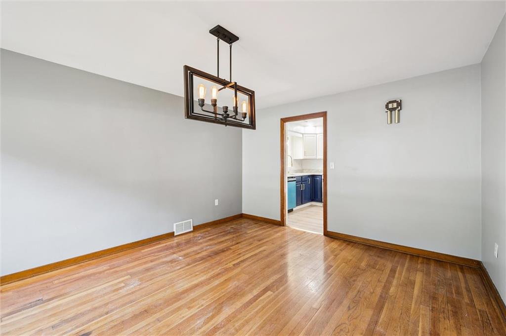 1167 Lapish Road Pittsburgh, PA 15212 - Photo 7 of 45 a view of an empty room with wooden floor and a window