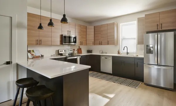 a kitchen with a sink a refrigerator a stove a microwave and cabinets