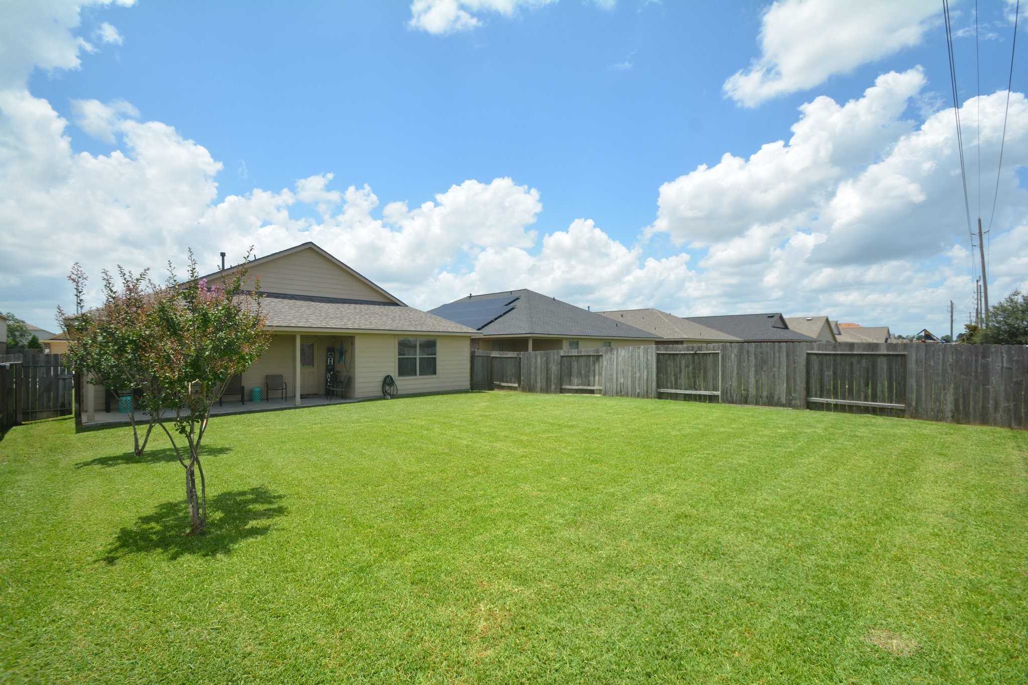 23318 Dukes Run Drive Spring, TX 77373 - Photo 40 of 41 Spacious backyard with a well-maintained lawn, fenced for privacy. Ideal for outdoor activities and relaxation.