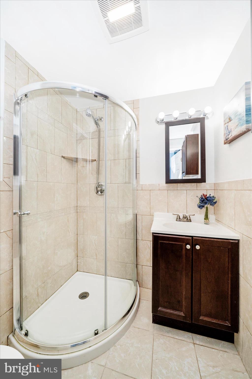 713 Seek Lane Silver Spring, MD 20912 - Photo 42 of 60 a bathroom with a sink a toilet and shower