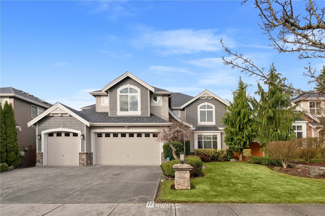 4421 220th Street Southeast Bothell, WA 98021 - Photo 1 of 39 a front view of a house with a yard and garage