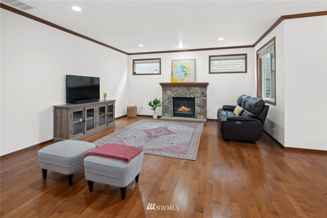 4421 220th Street Southeast Bothell, WA 98021 - Photo 12 of 39 a living room with furniture a flat screen tv and a fireplace