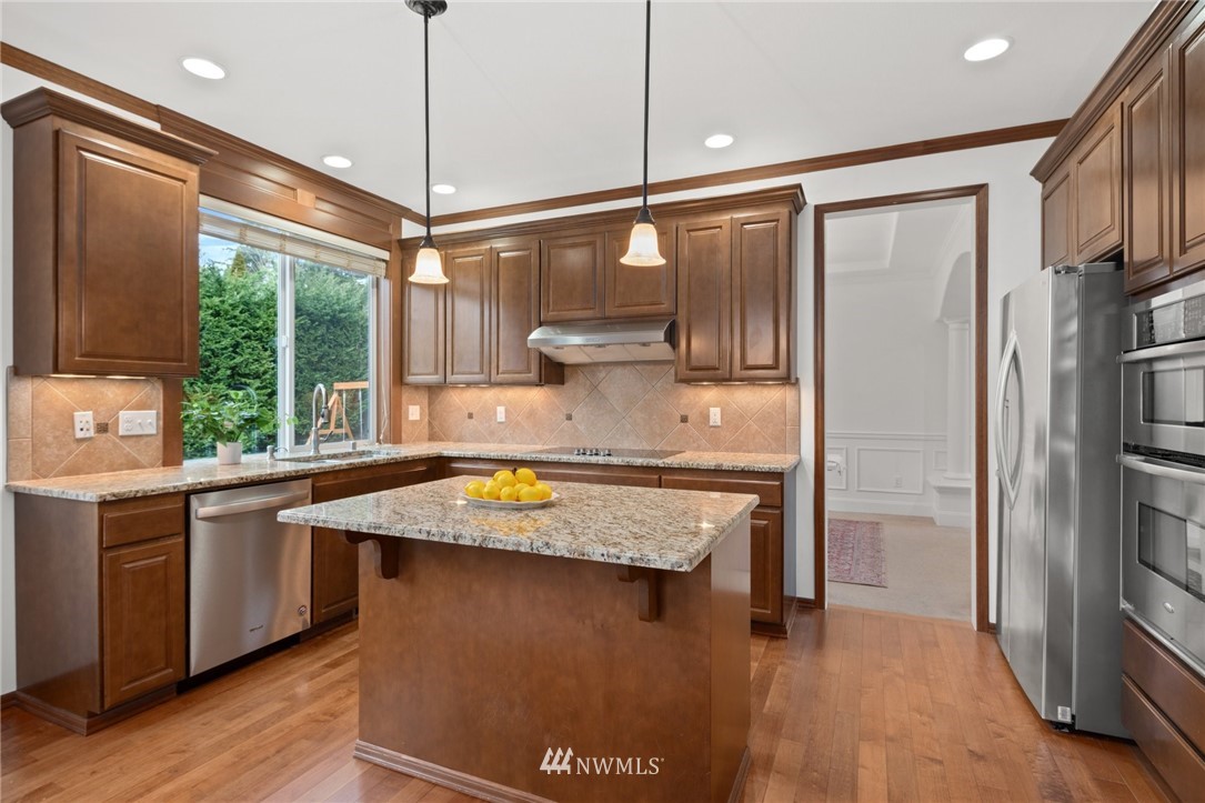 4421 220th Street Southeast Bothell, WA 98021 - Photo 15 of 39 a kitchen with stainless steel appliances granite countertop a refrigerator a sink and a stove
