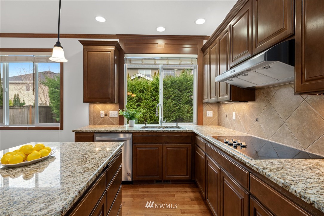 4421 220th Street Southeast Bothell, WA 98021 - Photo 17 of 39 a kitchen with stainless steel appliances granite countertop sink stove and refrigerator