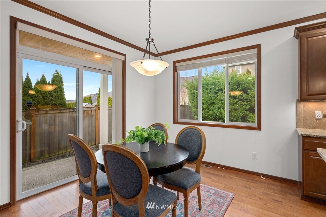 4421 220th Street Southeast Bothell, WA 98021 - Photo 18 of 39 a dining room with furniture a chandelier and wooden floor