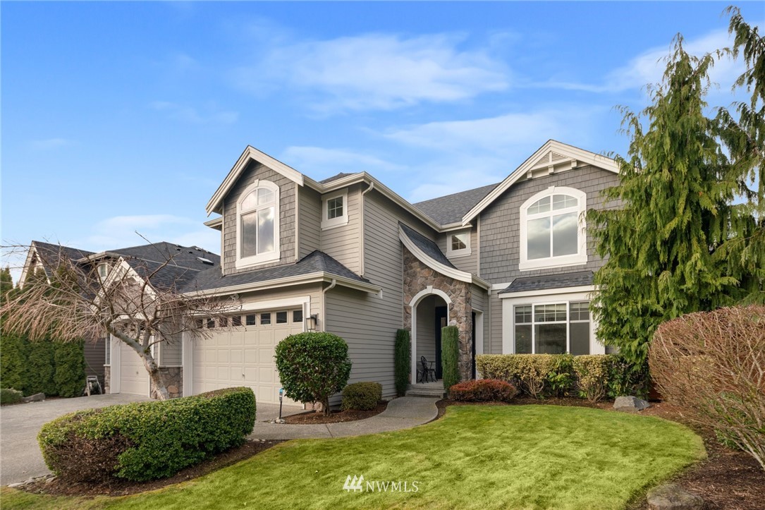 4421 220th Street Southeast Bothell, WA 98021 - Photo 2 of 39 a front view of a house with a yard