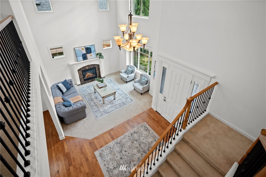 4421 220th Street Southeast Bothell, WA 98021 - Photo 21 of 39 a living room with furniture and a chandelier
