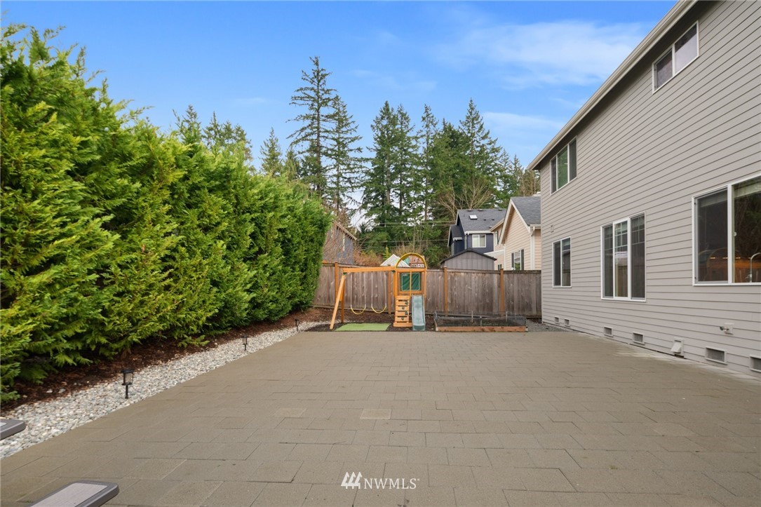 4421 220th Street Southeast Bothell, WA 98021 - Photo 34 of 39 a view of a house with a yard and garage