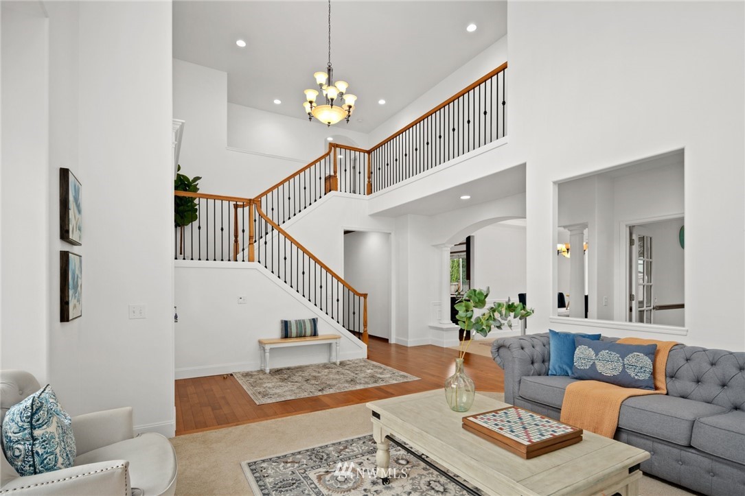4421 220th Street Southeast Bothell, WA 98021 - Photo 6 of 39 a living room with furniture and a chandelier