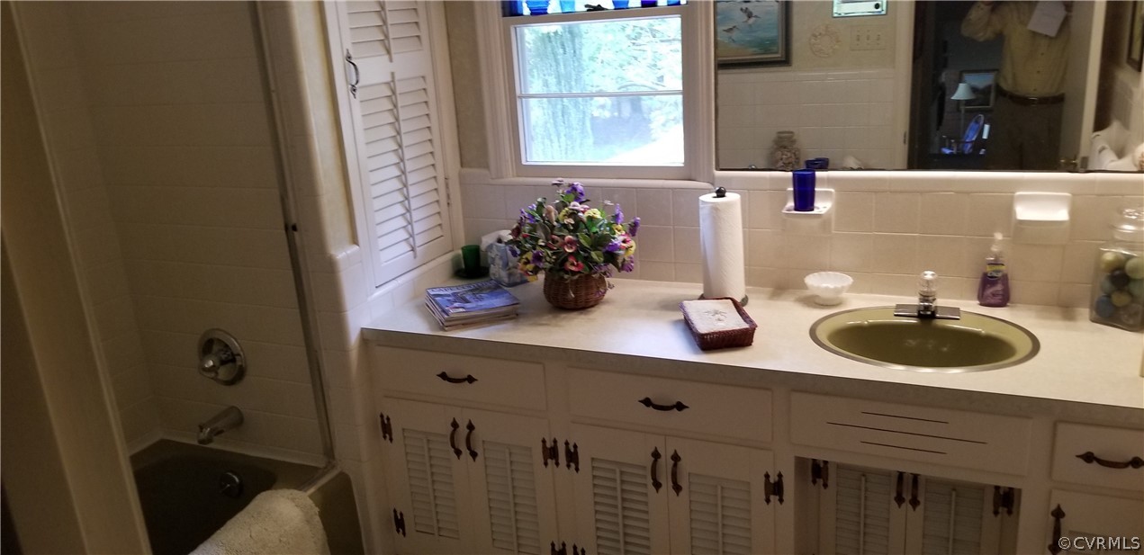 79 High School Road Buckingham, VA 23921 - Photo 14 of 26 a bathroom with a double vanity sink and a window