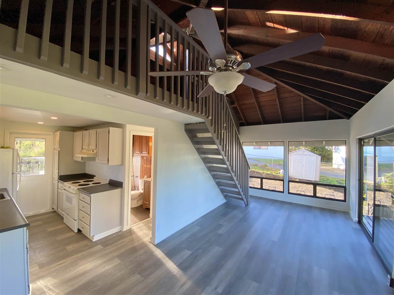 180 Ainakula Road Kula, HI 96790 - Photo 1 of 30 a view of a kitchen with a sink cabinets and wooden floor