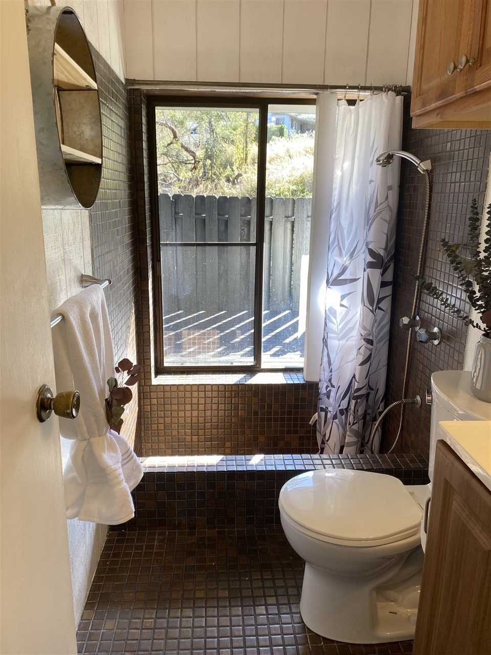 180 Ainakula Road Kula, HI 96790 - Photo 14 of 30 a bathroom with a sink a toilet a window and shower