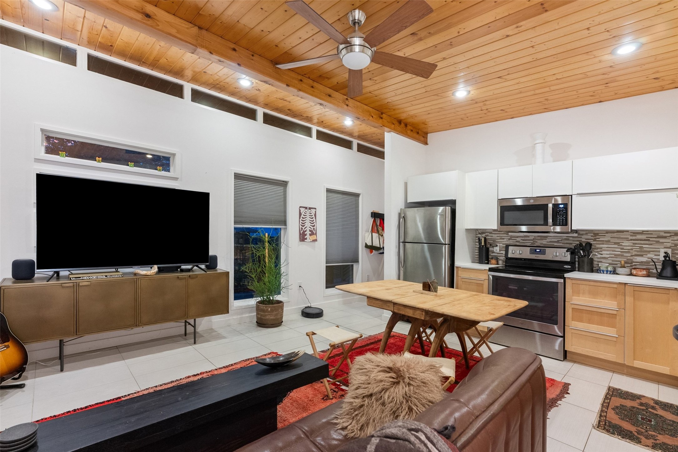 412 West Croslin Street Austin, TX 78752 - Photo 26 of 36 Exposed wood beams and vaulted ceilings define this contemporary kitchen and living space.