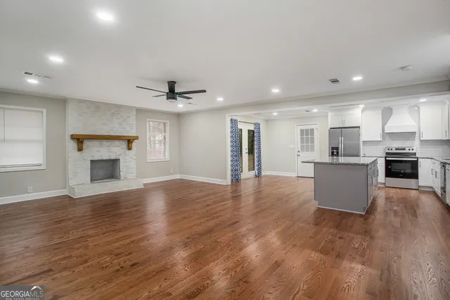 a view of a kitchen with a sink and refrigerator